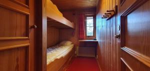 a small room with a small bed in a train at Sauna | Wi-Fi | Terrace | Wood stove | Cable TV in Lofsdalen +4 photos