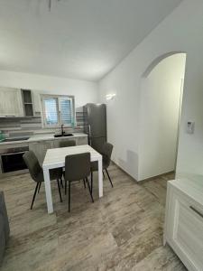 a kitchen with a white table and chairs in a room at casa Palau in Palau +12 photos