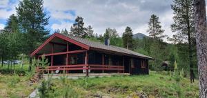 a house in the middle of a field at Sauna | Wi-Fi | Terrace | Wood stove | Cable TV in Lofsdalen