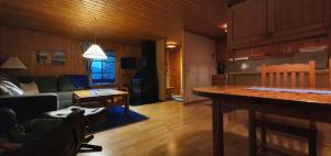 a living room with a couch and a table at Sauna | Wi-Fi | Terrace | Wood stove | Cable TV in Lofsdalen