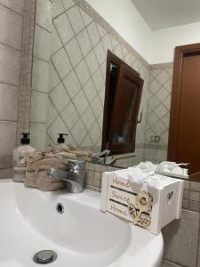 a bathroom sink with a box on top of it at Casa Vacanza Betty in Partanna