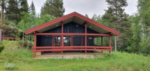 a small cabin in the middle of a field at Sauna | Wi-Fi | Terrace | Wood stove | Cable TV in Lofsdalen