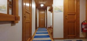 a hallway with a blue and white striped carpet at Sauna | Wi-Fi | Terrace | Wood stove | Cable TV in Lofsdalen +6 photos