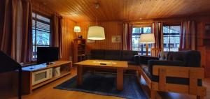 a living room with a couch and a table at Sauna | Wi-Fi | Terrace | Wood stove | Cable TV in Lofsdalen