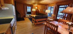 a living room with a couch and a table at Sauna | Wi-Fi | Terrace | Wood stove | Cable TV in Lofsdalen