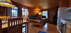 a living room with a kitchen and a dining room at Sauna | Wi-Fi | Terrace | Wood stove | Cable TV in Lofsdalen