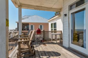 a person standing on the front porch of a house at Pour House in Dauphin Island