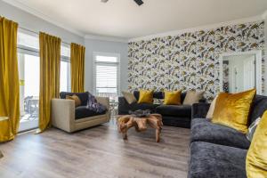 a living room with two couches and a table at Pour House in Dauphin Island