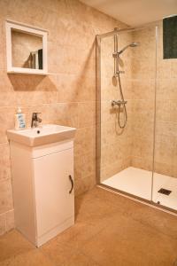 a bathroom with a shower and a sink at Little Rissington - Barn Six in Little Rissington +9 photos