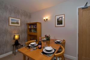 a dining room table with chairs and a wooden tableablish at Acer View in Bowness-on-Windermere