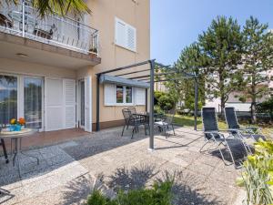 a patio with chairs and a table in front of a building at Apartment Mirta by Interhome in Šilo +21 photos