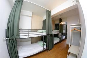 a room with three bunk beds in a room at Travel & Live Porto Hostel in Porto