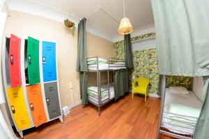 a room with two bunk beds and a room with a window at Travel & Live Porto Hostel in Porto