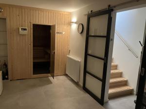 a hallway with a door to a room with stairs at Holiday Home Villa Vrijheid by Interhome in Hollum