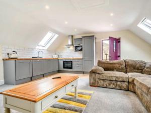 a living room with a couch and a table at Little Rissington - The Studio Apartment in Little Rissington +9 photos