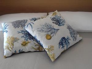 a pillow sitting on top of a bed at Apartment Laura-8 by Interhome in Marina di Ascea +6 photos