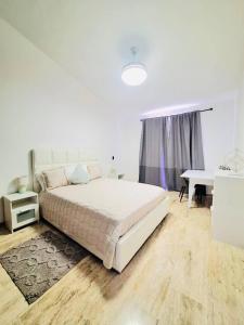 a white bedroom with a bed and a desk at GLOBALSTAY Cocotal Condo in Punta Cana in Punta Cana +34 photos