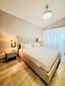 a bedroom with a large white bed and a window at GLOBALSTAY Cocotal Condo in Punta Cana in Punta Cana