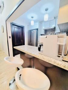 a kitchen with a white counter and a white microwave at GLOBALSTAY Cocotal Condo in Punta Cana in Punta Cana