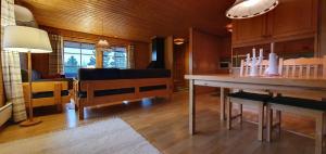 a living room with a table and a couch at Sauna | Wi-Fi | Terrace | Wood stove | Cable TV in Lofsdalen +5 photos