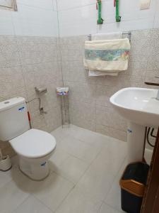 a bathroom with a toilet and a sink at AMAL HoME in Ouagadougou +16 photos