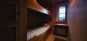 a small room with a bunk bed with a window at Sauna | Wi-Fi | Terrace | Wood stove | Cable TV in Lofsdalen