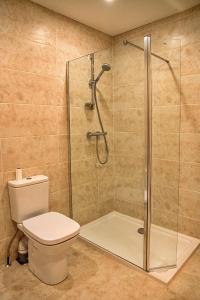 a bathroom with a toilet and a glass shower at Little Rissington - Barn Seven in Little Rissington +6 photos
