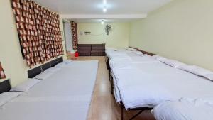 a room with a row of beds in it at LD Guest House, Ayodhya in Ayodhya