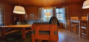 a living room with a table and a couch at Sauna | Wi-Fi | Terrace | Wood stove | Cable TV in Lofsdalen