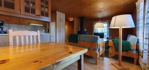 a kitchen with a wooden table and a dining room at Sauna | Wi-Fi | Terrace | Wood stove | Cable TV in Lofsdalen