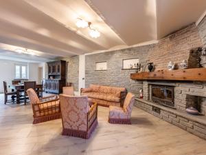 a living room with a couch and a fireplace at Holiday Home Villa Creviolo by Interhome in Loazzolo