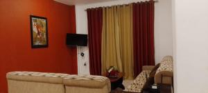a living room with a couch and a chair at Dil Apartments 2 in Mount Lavinia