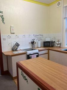 a kitchen with a stove and a counter top at Shirleys apartment in Rhyl +2 photos