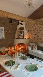 a living room with a table and a fireplace at Merian's House in Fethiye +13 photos