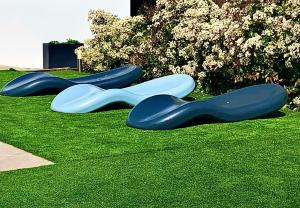 a group of three blue plastic objects on the grass at Villa La Roca con casita independiente in Guadarrama