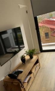 a room with a desk with a keyboard and potted plants at Le jardin 211 in George