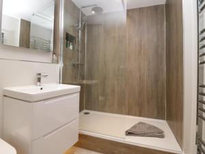 a bathroom with a white sink and a shower at Holme Fell View in Sedbergh