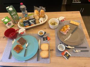 a table topped with plates of food and bread at Casa Anita in Marsala
