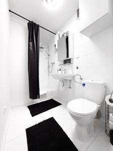 a white bathroom with a toilet and a sink at Relax Ferienwohnung Roetgen in Roetgen +101 photos