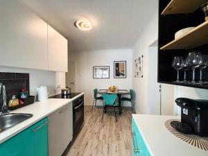 a kitchen with a table and chairs in a room at Relax Ferienwohnung Roetgen in Roetgen