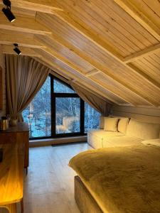 a bedroom with a bed and a large window at Turgensai Visitor Center in Taūtürgen