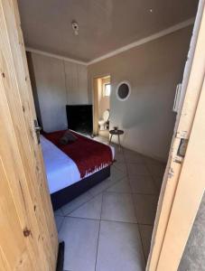 a bedroom with a bed with a red blanket at Begin Guesthouse in Ermelo