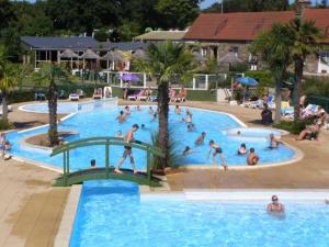 a group of people in a pool at a resort at Camping 4 étoiles - Piscine - ccafgef in La Haye-du-Puits