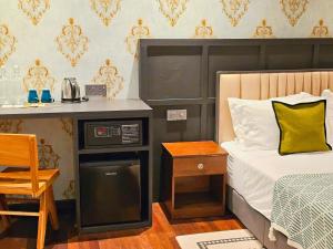 a bedroom with a bed with a microwave and a table at Carnarvon Suites in George Town +172 photos