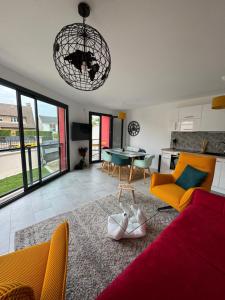 a living room with a red couch and a table at La maison rouge proche de Paris in Fontenay-sous-Bois +16 photos