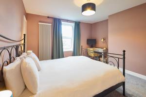 a bedroom with a large bed and a window at Host & Stay - Cheviot Street in Wooler