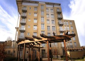 a tall building with a sculpture in front of it at Reading Spacious Two Bedroom Apartment in Reading