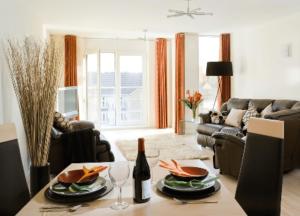 a living room with a table and a couch at Reading Spacious Two Bedroom Apartment in Reading