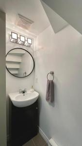 a bathroom with a sink and a mirror at 29SV-B1 Newo Retro in Quebec City +10 photos