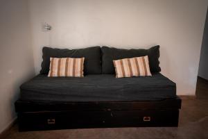 a black couch with two pillows on it at Ciro Dpto in Federación